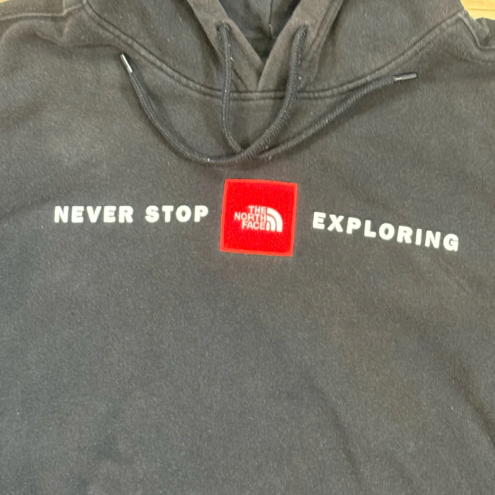 The North Face Black Hoodie with Red Logo Patch